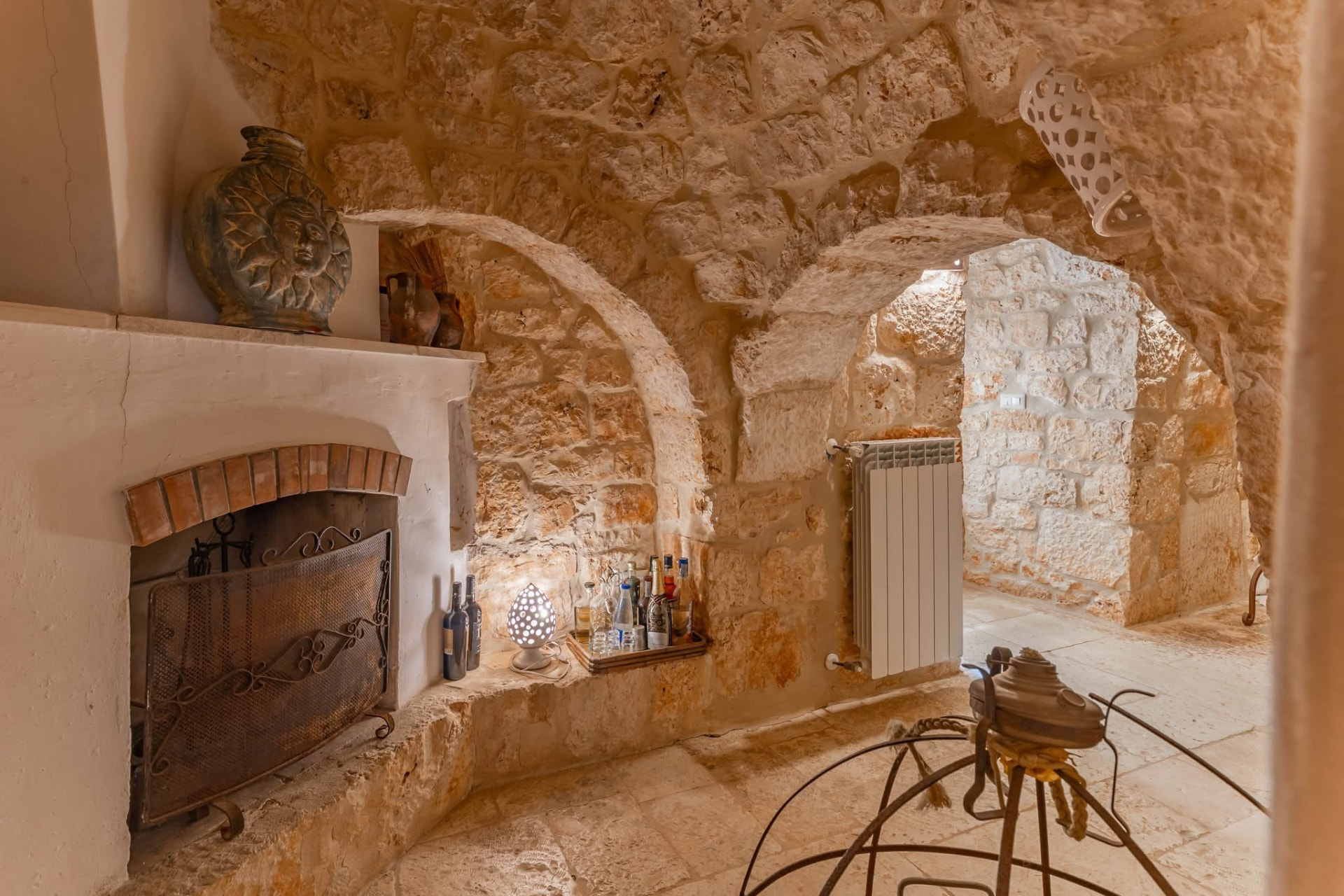 Serene limestone bedroom beneath a trullo cone